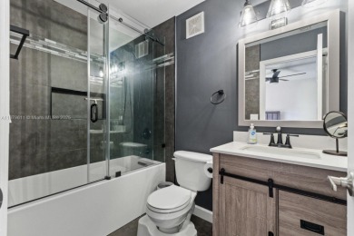 Affordable and stylishly renovated waterfront townhouse in the on Woodmont Country Club in Florida - for sale on GolfHomes.com, golf home, golf lot