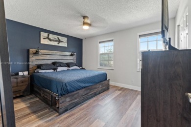 Affordable and stylishly renovated waterfront townhouse in the on Woodmont Country Club in Florida - for sale on GolfHomes.com, golf home, golf lot