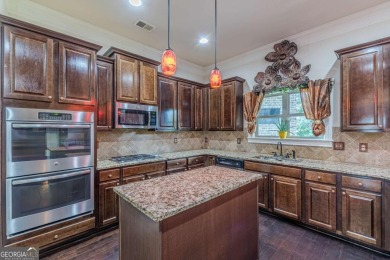 Discover this beautifully designed 4-sided brick home tucked on Crystal Lake Golf and Country Club in Georgia - for sale on GolfHomes.com, golf home, golf lot