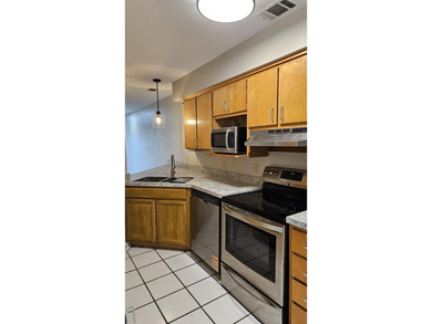 Renovated contemporary townhome with fun diagonal design on Hilaman Park Golf Course in Florida - for sale on GolfHomes.com, golf home, golf lot