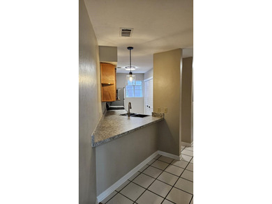 Renovated contemporary townhome with fun diagonal design on Hilaman Park Golf Course in Florida - for sale on GolfHomes.com, golf home, golf lot