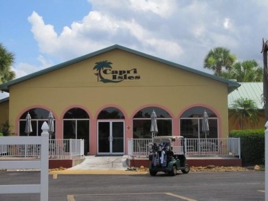 Located in the middle of just about anything you could need on Capri Isle Golf Club in Florida - for sale on GolfHomes.com, golf home, golf lot