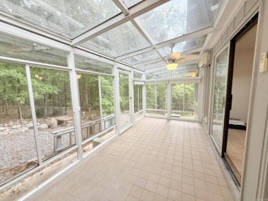 Enclosed glass sunroom offers year-round enjoyment from this on Cortez Golf Course in Arkansas - for sale on GolfHomes.com, golf home, golf lot