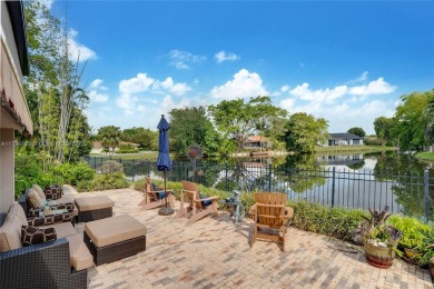 Welcome to this stunning 4 bed, 2.5-bath lakefront home located on Jacaranda Golf Club in Florida - for sale on GolfHomes.com, golf home, golf lot