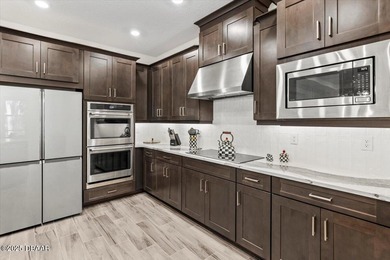 Experience luxury living in the gated Windchase section of on Halifax Plantation Golf Club in Florida - for sale on GolfHomes.com, golf home, golf lot