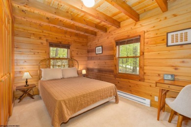 Escape to 'Rustic Refuge', a charming LOG CHALET nestled within on Alpine Lake Resort in West Virginia - for sale on GolfHomes.com, golf home, golf lot