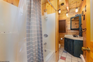 Escape to 'Rustic Refuge', a charming LOG CHALET nestled within on Alpine Lake Resort in West Virginia - for sale on GolfHomes.com, golf home, golf lot