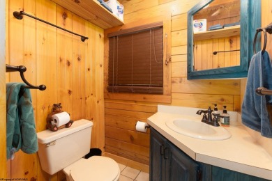 Escape to 'Rustic Refuge', a charming LOG CHALET nestled within on Alpine Lake Resort in West Virginia - for sale on GolfHomes.com, golf home, golf lot