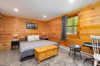 Escape to 'Rustic Refuge', a charming LOG CHALET nestled within on Alpine Lake Resort in West Virginia - for sale on GolfHomes.com, golf home, golf lot