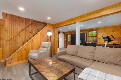 Escape to 'Rustic Refuge', a charming LOG CHALET nestled within on Alpine Lake Resort in West Virginia - for sale on GolfHomes.com, golf home, golf lot