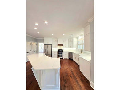 Perfectly positioned on the 18th tee box of the prestigious on Okefenokee Country Club in Georgia - for sale on GolfHomes.com, golf home, golf lot