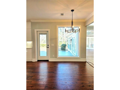 Perfectly positioned on the 18th tee box of the prestigious on Okefenokee Country Club in Georgia - for sale on GolfHomes.com, golf home, golf lot