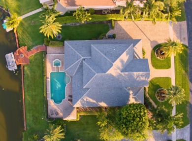 Enjoy lakefront sunsets from this elegant home in the gated on Greenview Cove Golf Club in Florida - for sale on GolfHomes.com, golf home, golf lot