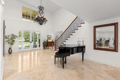 Enjoy lakefront sunsets from this elegant home in the gated on Greenview Cove Golf Club in Florida - for sale on GolfHomes.com, golf home, golf lot