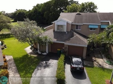 Welcome to this beautiful end unit located on the 5th green of on Woodmont Country Club in Florida - for sale on GolfHomes.com, golf home, golf lot