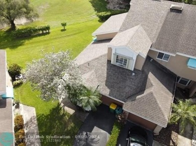 Welcome to this beautiful end unit located on the 5th green of on Woodmont Country Club in Florida - for sale on GolfHomes.com, golf home, golf lot