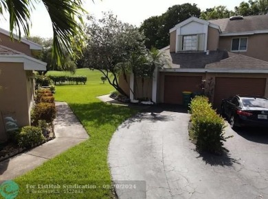 Welcome to this beautiful end unit located on the 5th green of on Woodmont Country Club in Florida - for sale on GolfHomes.com, golf home, golf lot