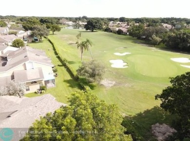 Welcome to this beautiful end unit located on the 5th green of on Woodmont Country Club in Florida - for sale on GolfHomes.com, golf home, golf lot