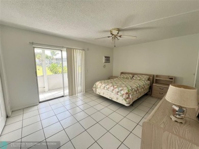 ENJOY THE CONVENIENCE OF FIRST FLOOR LIVING IN THIS ONE BEDROOM on Hillsboro Pines Golf in Florida - for sale on GolfHomes.com, golf home, golf lot