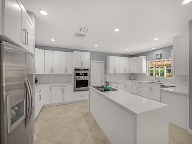 Discover comfortable luxury in this expansive single-story on Atlantis Golf Club in Florida - for sale on GolfHomes.com, golf home, golf lot