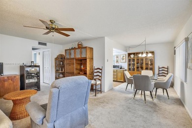 Enjoy serene lake and golf course views from this first-floor on Flamingo Lakes Country Club in Florida - for sale on GolfHomes.com, golf home, golf lot