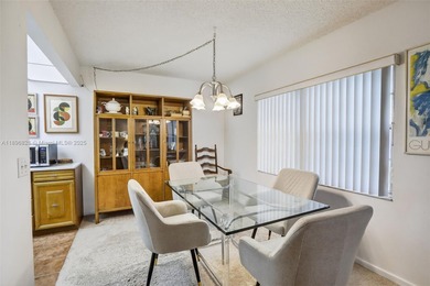 Enjoy serene lake and golf course views from this first-floor on Flamingo Lakes Country Club in Florida - for sale on GolfHomes.com, golf home, golf lot