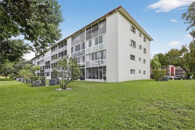 Enjoy serene lake and golf course views from this first-floor on Flamingo Lakes Country Club in Florida - for sale on GolfHomes.com, golf home, golf lot