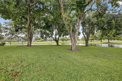 Enjoy serene lake and golf course views from this first-floor on Flamingo Lakes Country Club in Florida - for sale on GolfHomes.com, golf home, golf lot
