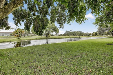 Enjoy serene lake and golf course views from this first-floor on Flamingo Lakes Country Club in Florida - for sale on GolfHomes.com, golf home, golf lot