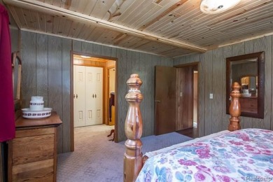 Welcome to your Up North getaway or your year round home inside on Lost Lake Woods Club in Michigan - for sale on GolfHomes.com, golf home, golf lot