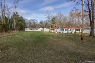 Welcome to your Up North getaway or your year round home inside on Lost Lake Woods Club in Michigan - for sale on GolfHomes.com, golf home, golf lot