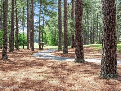 Overlooking the 7th green of Pinewild's Magnolia Course, this on Pinewild Country Club of Pinehurst in North Carolina - for sale on GolfHomes.com, golf home, golf lot
