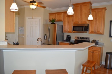 Beautiful home in quaint, white-picket-fenced, gated community on Fairway Oaks at Magnolia Golf Course in Florida - for sale on GolfHomes.com, golf home, golf lot