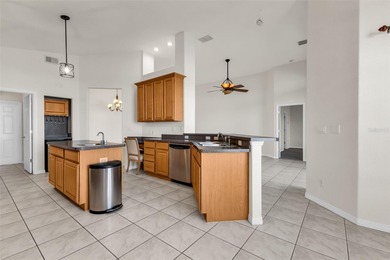 Experience the Florida lifestyle at its finest in this on Kings Gate Golf Club in Florida - for sale on GolfHomes.com, golf home, golf lot