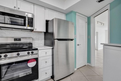 GROUND LEVEL CONDO WITH STUNNING LAKE & GOLF VIEWS Discover on Atlantis Golf Club in Florida - for sale on GolfHomes.com, golf home, golf lot