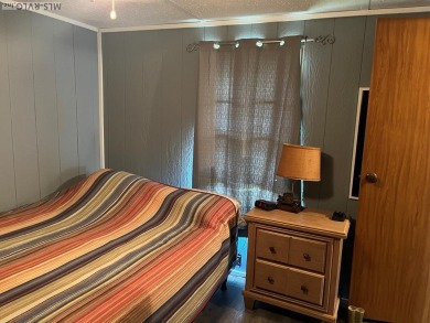 MOVE-IN READY, FURNISHED PROPERTY FOR LESS THAN $100K.  This on River Ridge Golf Club in Virginia - for sale on GolfHomes.com, golf home, golf lot