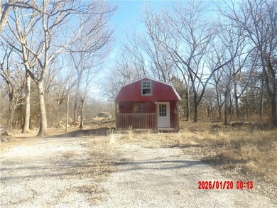 Enjoy this weekend/vacation retreat nestled in the trees on 2 on Sugar Valley Lakes Golf Course in Kansas - for sale on GolfHomes.com, golf home, golf lot