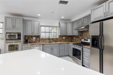 This elegant Spanish home filled with natural light, is situated on Granada Golf Club in Florida - for sale on GolfHomes.com, golf home, golf lot