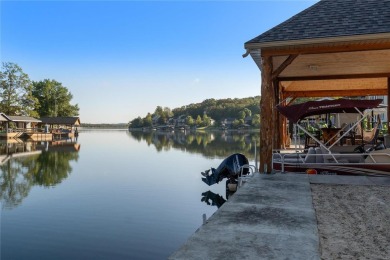 This 4-bedroom, 3-bathroom lake front Atrium Ranch home boasts on Raintree Country Club in Missouri - for sale on GolfHomes.com, golf home, golf lot