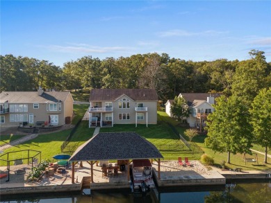 This 4-bedroom, 3-bathroom lake front Atrium Ranch home boasts on Raintree Country Club in Missouri - for sale on GolfHomes.com, golf home, golf lot