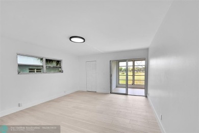 This stunning corner unit features high-quality waterproof vinyl on Wynmoor Golf Course in Florida - for sale on GolfHomes.com, golf home, golf lot