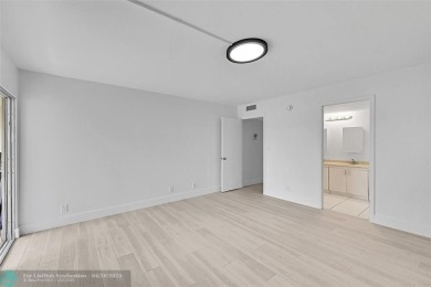 This stunning corner unit features high-quality waterproof vinyl on Wynmoor Golf Course in Florida - for sale on GolfHomes.com, golf home, golf lot