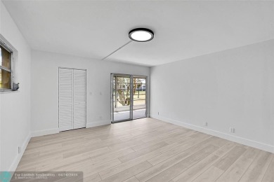 This stunning corner unit features high-quality waterproof vinyl on Wynmoor Golf Course in Florida - for sale on GolfHomes.com, golf home, golf lot