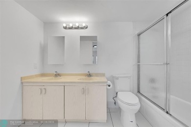 This stunning corner unit features high-quality waterproof vinyl on Wynmoor Golf Course in Florida - for sale on GolfHomes.com, golf home, golf lot