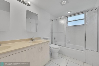 This stunning corner unit features high-quality waterproof vinyl on Wynmoor Golf Course in Florida - for sale on GolfHomes.com, golf home, golf lot