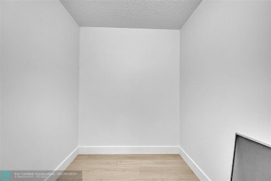 This stunning corner unit features high-quality waterproof vinyl on Wynmoor Golf Course in Florida - for sale on GolfHomes.com, golf home, golf lot