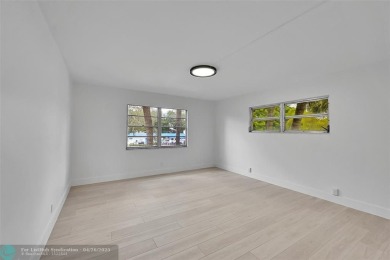 This stunning corner unit features high-quality waterproof vinyl on Wynmoor Golf Course in Florida - for sale on GolfHomes.com, golf home, golf lot