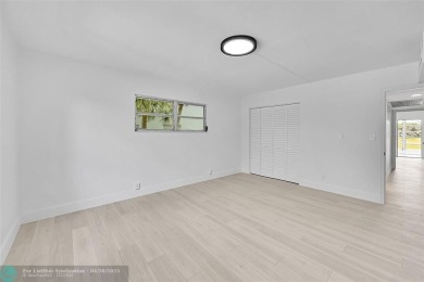 This stunning corner unit features high-quality waterproof vinyl on Wynmoor Golf Course in Florida - for sale on GolfHomes.com, golf home, golf lot