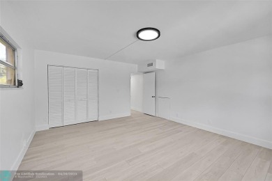 This stunning corner unit features high-quality waterproof vinyl on Wynmoor Golf Course in Florida - for sale on GolfHomes.com, golf home, golf lot