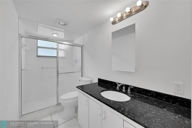 This stunning corner unit features high-quality waterproof vinyl on Wynmoor Golf Course in Florida - for sale on GolfHomes.com, golf home, golf lot